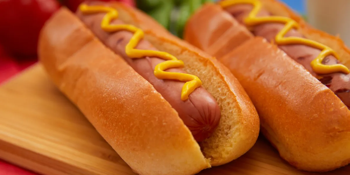 Americans will eat 150 million hot dogs today. One specific American is predicted to eat 70 of them