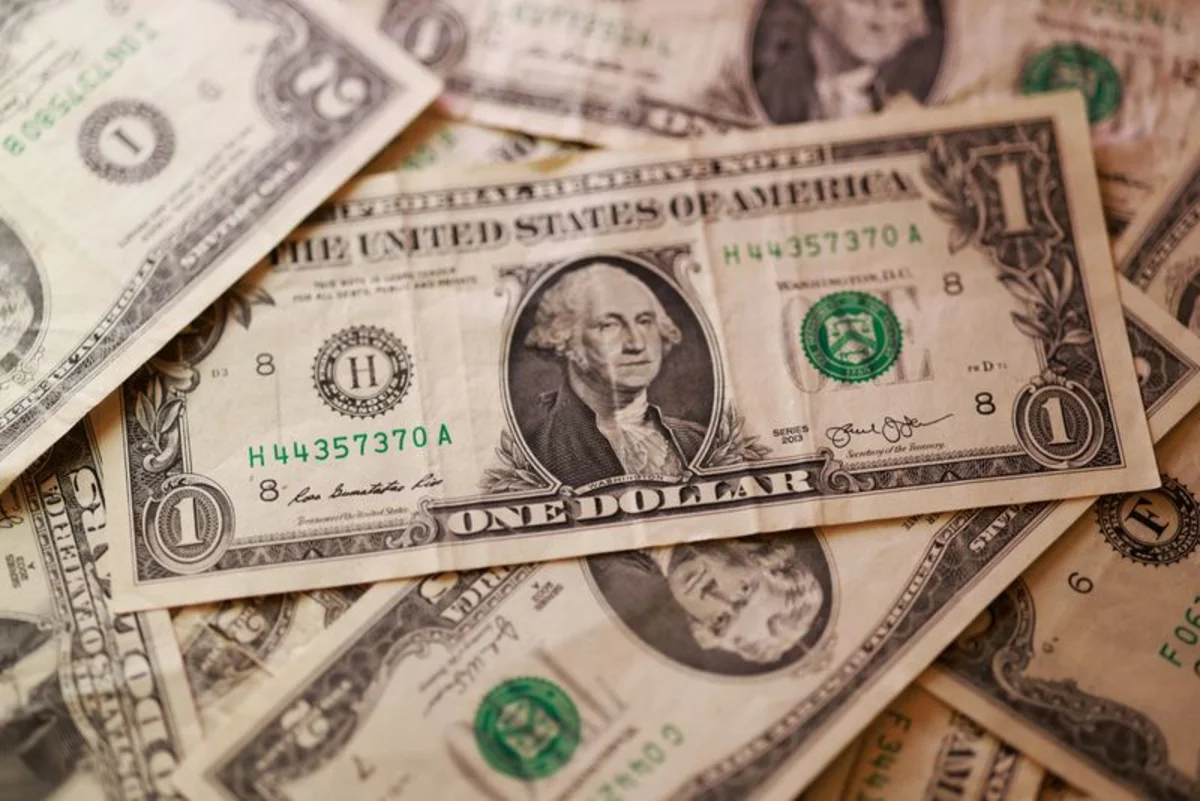 Dollar edges up, loonie drops after U.S. announces tariffs
