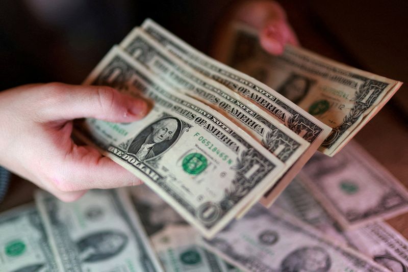 Dollar slips as markets wait on Warsh's Fed debut